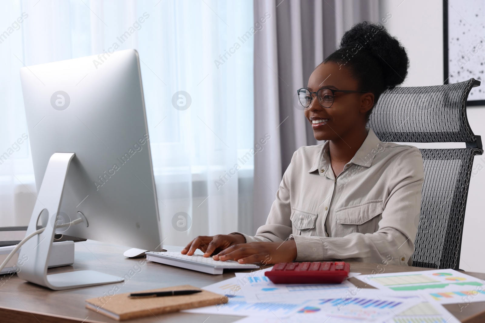 Photo of Professional accountant working on computer at wooden desk in office