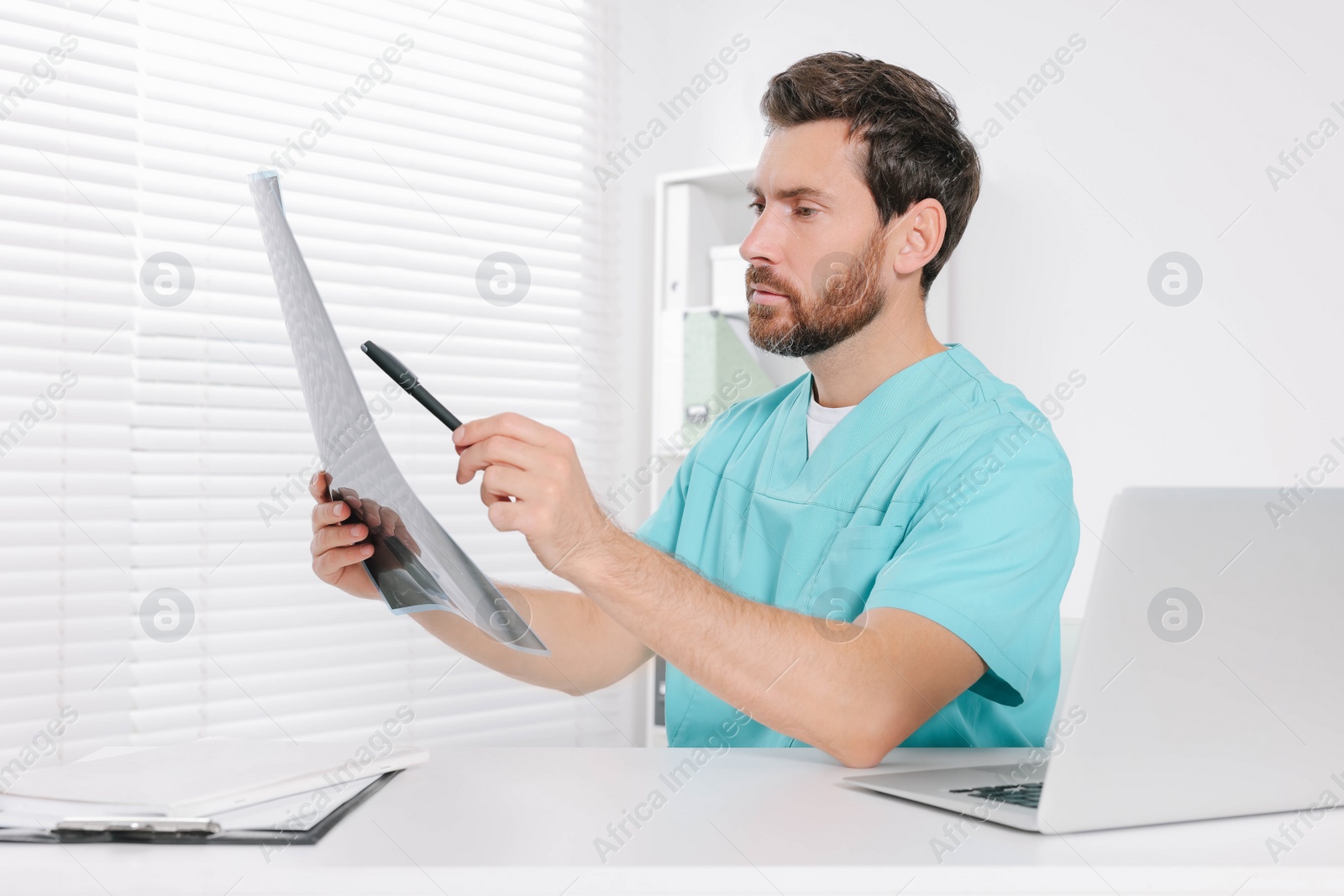 Photo of Doctor examining neck MRI scan in hospital