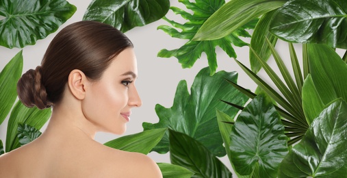 Beautiful young woman and tropical leaves, banner design. Spa portrait