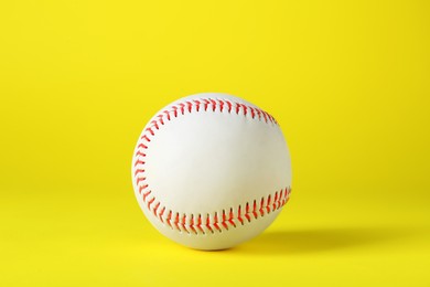 Photo of Baseball ball on yellow background. Sports game
