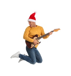 Photo of Man in Santa hat jumping with electric guitar on white background. Christmas music