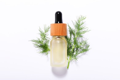 Photo of Bottle of essential oil and fresh dill on white background, top view