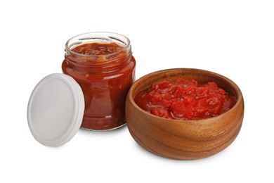 Glass jar and bowl of delicious lecho on white background