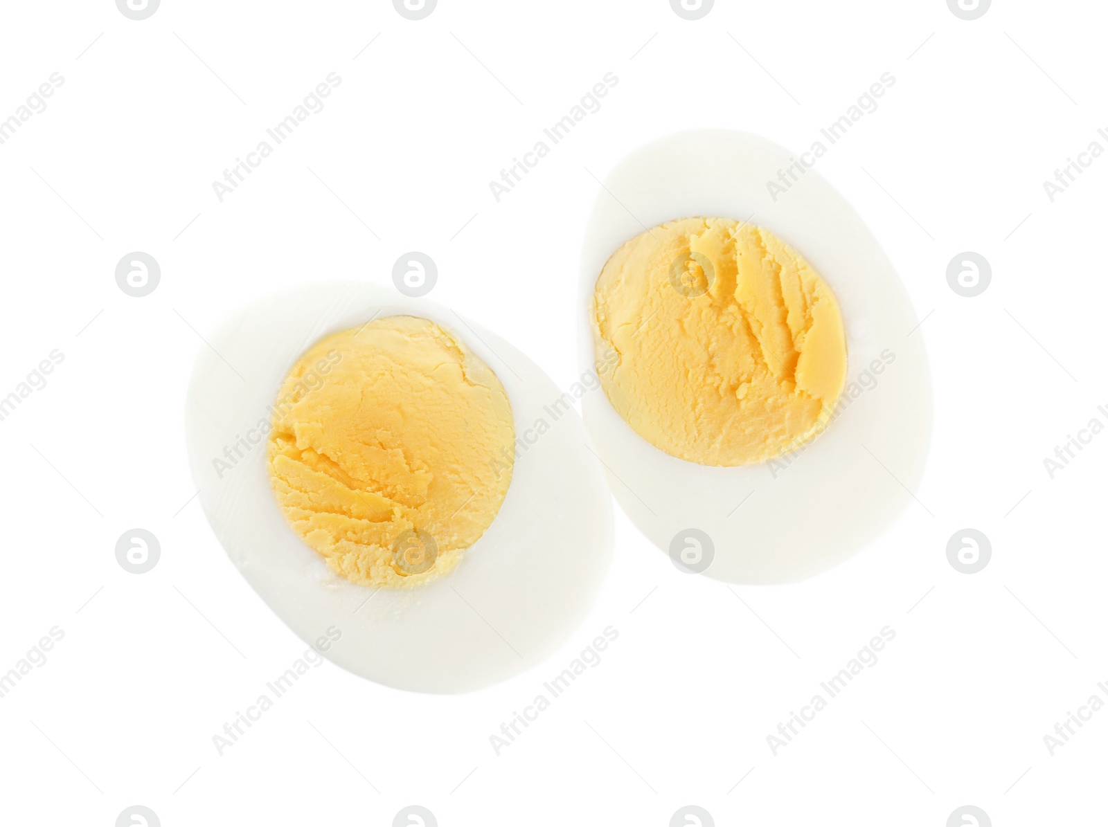 Photo of Halves of fresh hard boiled chicken egg isolated on white, top view