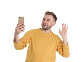 Young man using video chat on smartphone against white background