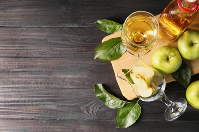 Photo of Flat lay composition with delicious apple cider on wooden table, space for text
