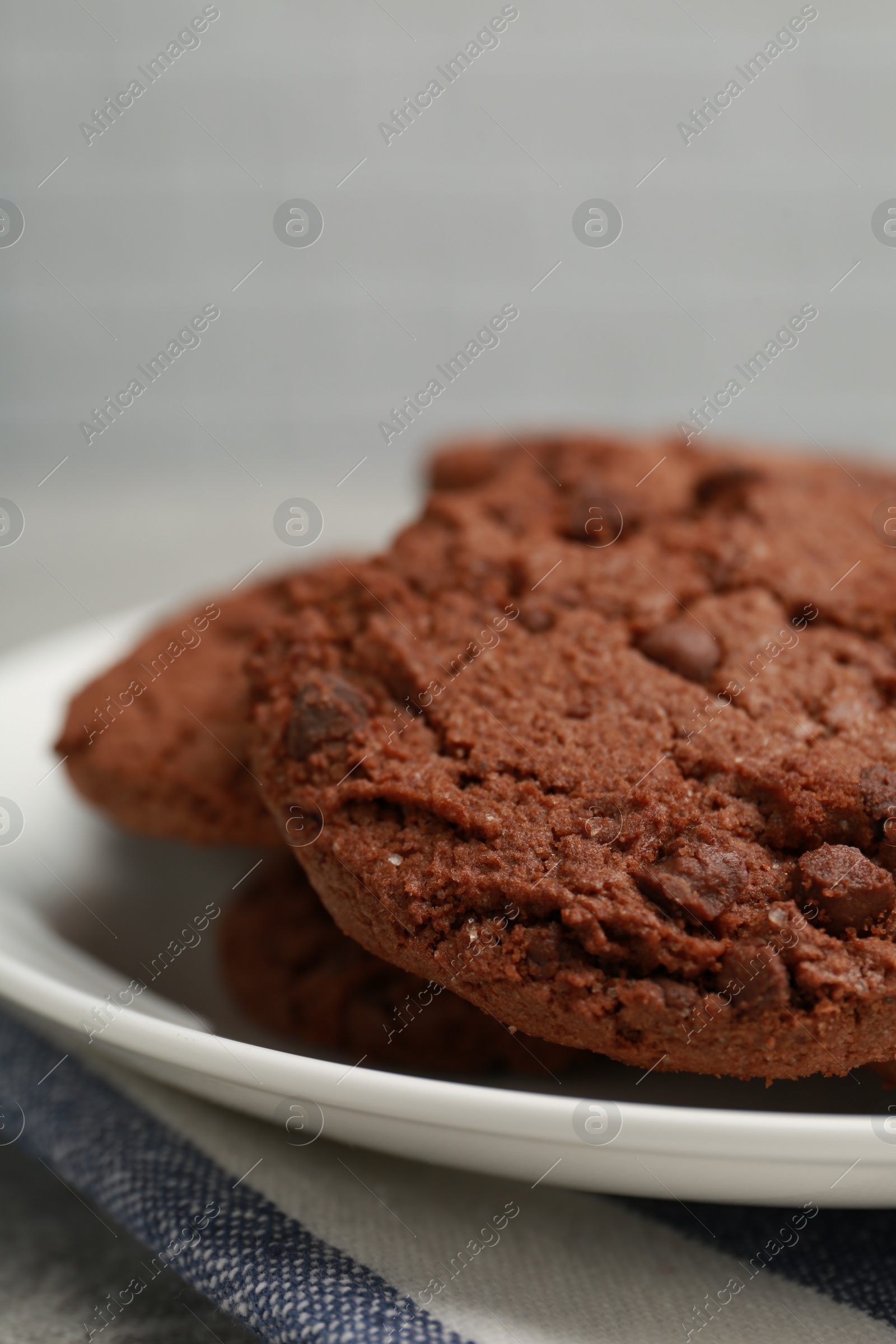 Photo of Delicious chocolate chip cookies on plate, closeup