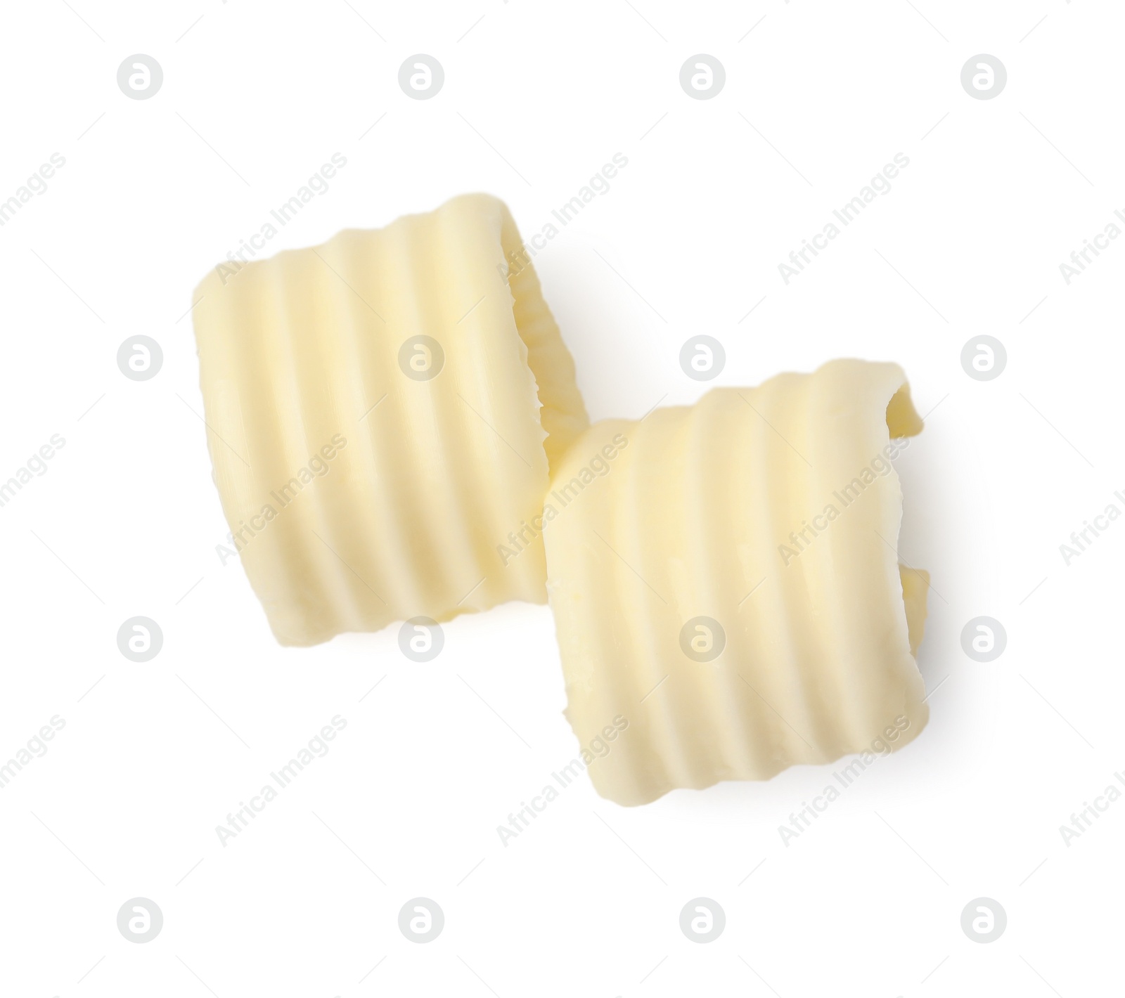Photo of Two tasty butter curls isolated on white, top view