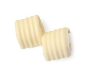 Photo of Two tasty butter curls isolated on white, top view