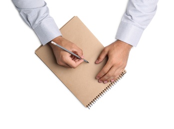Photo of Man with pencil and notepad on white background, top view. Closeup of hands
