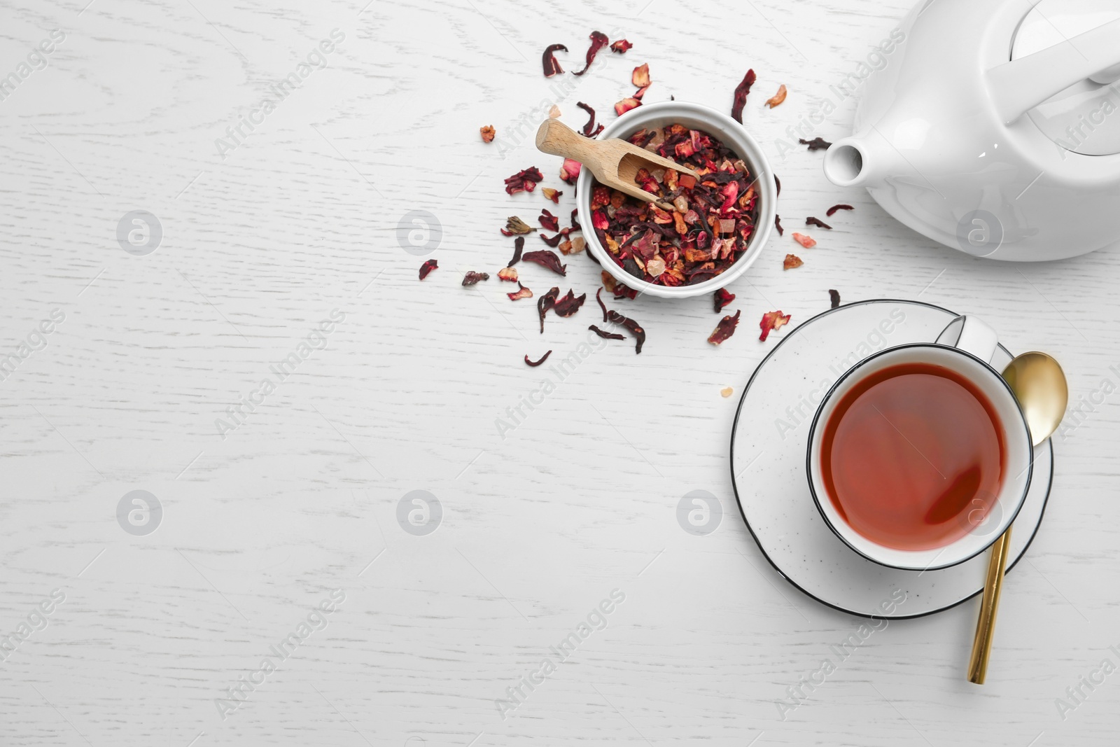 Photo of Composition with hibiscus tea on white wooden background, flat lay. Space for text