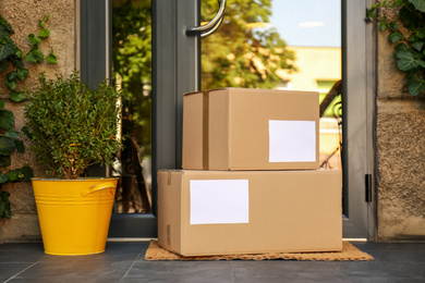 Delivered parcels on door mat near entrance