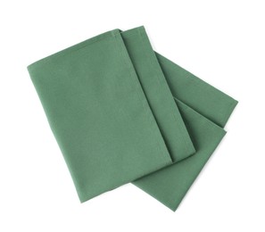 Photo of New clean green cloth napkins isolated on white, top view