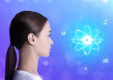 Woman and virtual model of atom on blue background