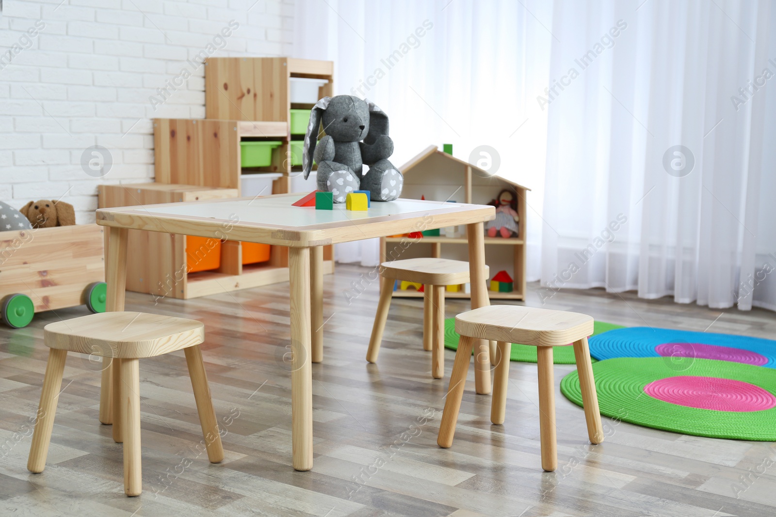 Photo of Modern child room interior with table and stools