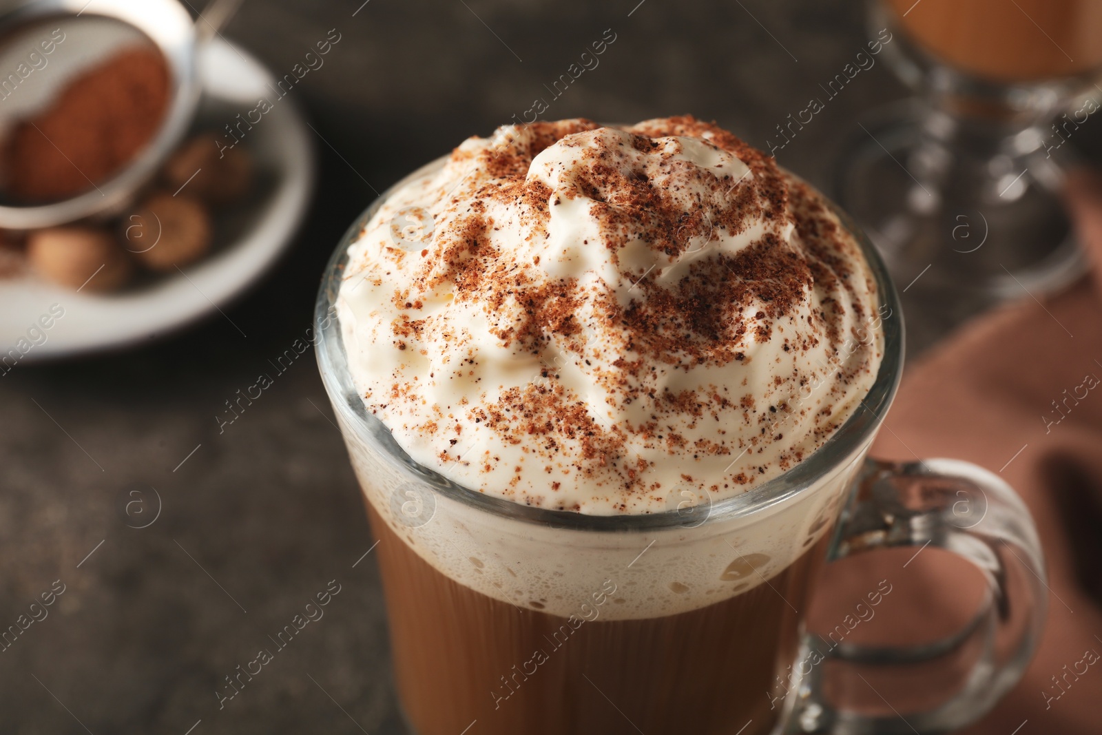 Photo of Hot drink with nutmeg powder in cup, closeup