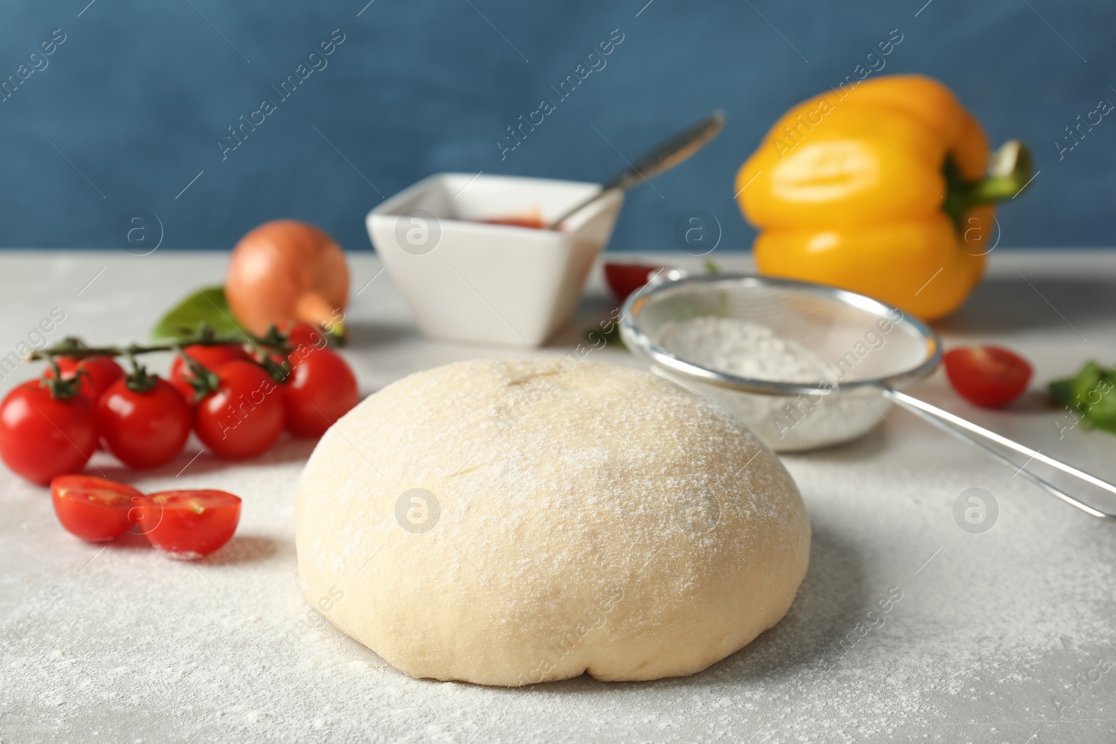 Photo of Fresh dough and ingredients for pizza on table