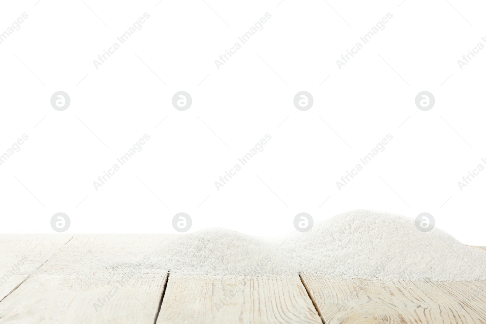 Photo of Artificial snow on wooden table against white background. Christmas decor