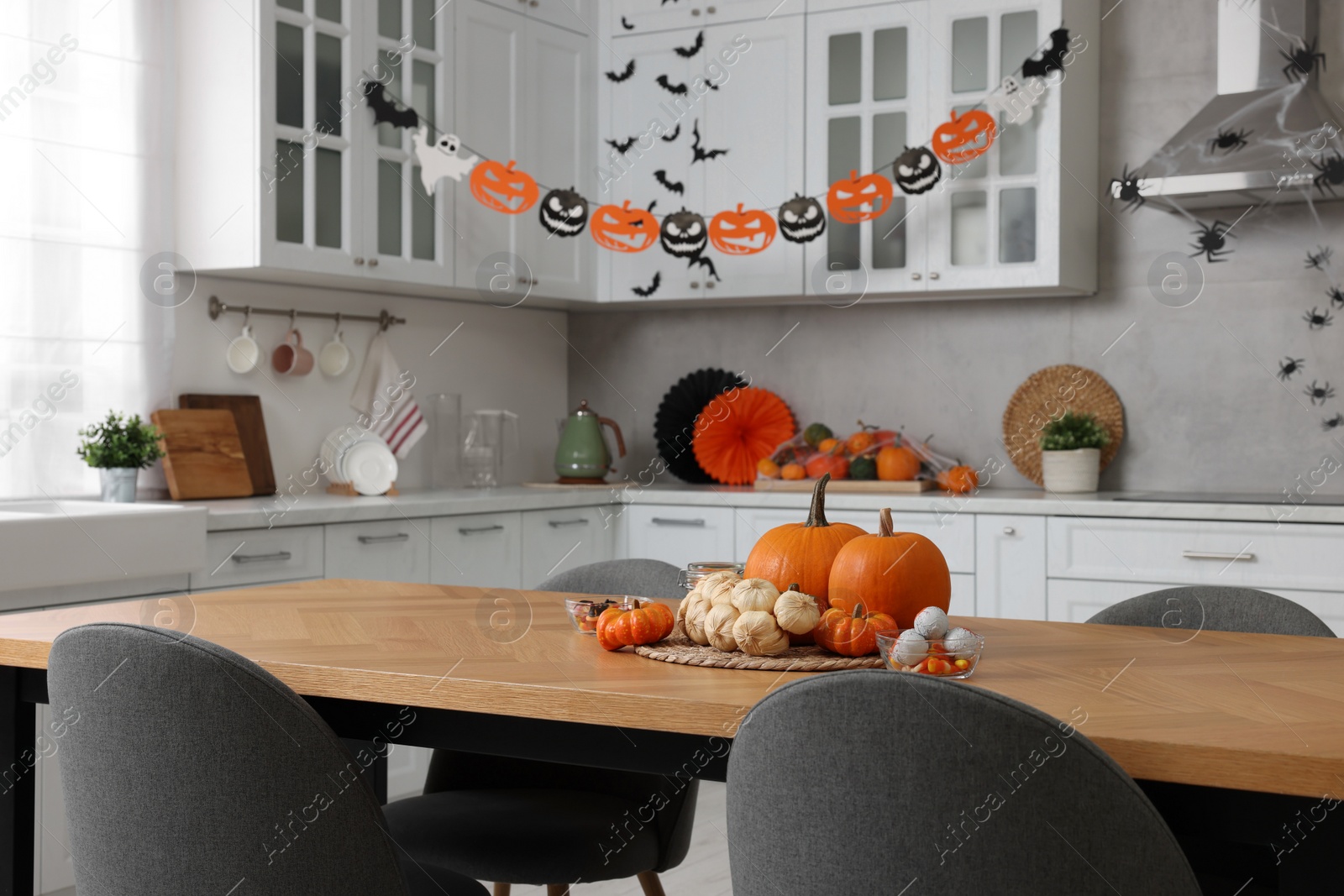 Photo of Stylish kitchen interior with festive decor. Halloween celebration