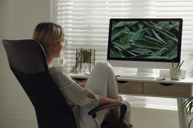 Woman resting on chair near workplace in room. Interior design