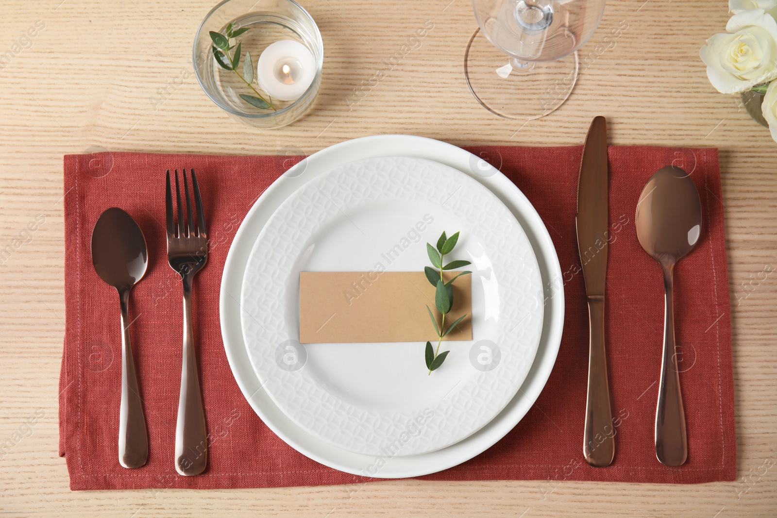 Photo of Elegant festive table setting with blank card in restaurant