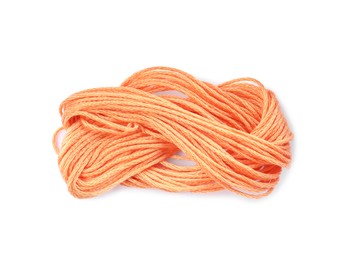 Photo of Pale orange embroidery thread on white background