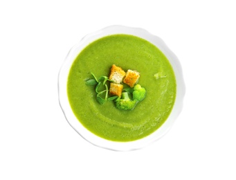 Photo of Bowl of broccoli cream soup with croutons on white background, top view