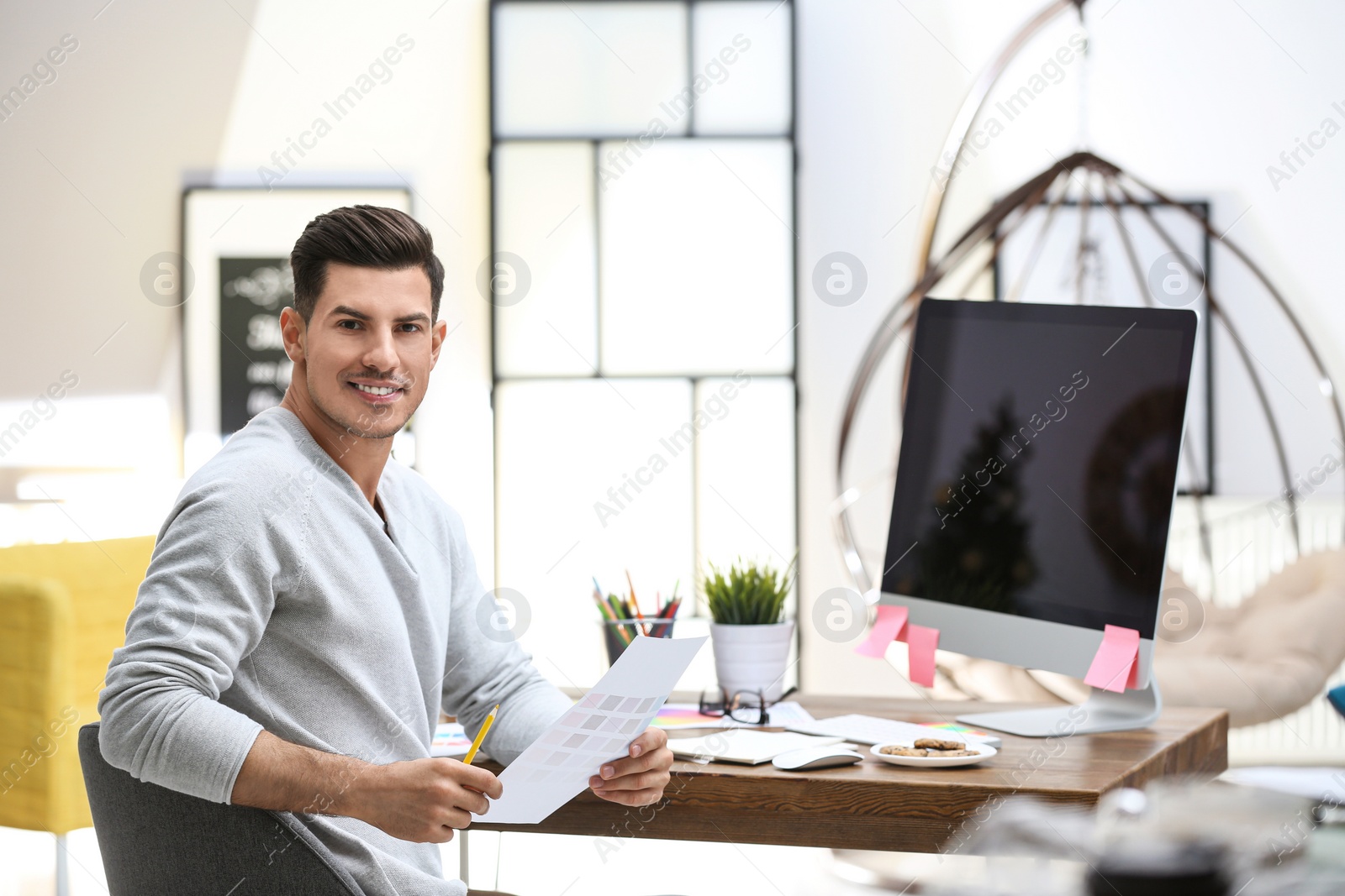 Photo of Male designer working at desk in office