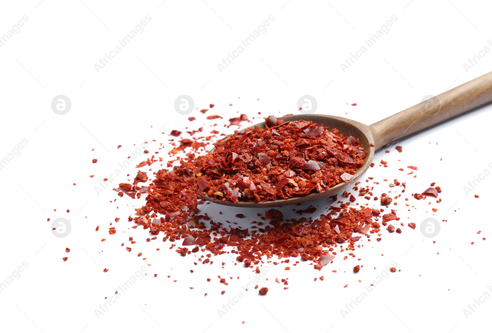 Photo of Spoon with crushed chili pepper on white background