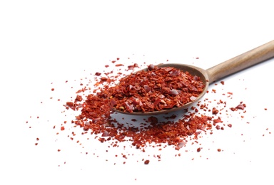 Photo of Spoon with crushed chili pepper on white background