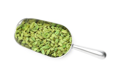Photo of Metal scoop with dry cardamom seeds isolated on white, top view