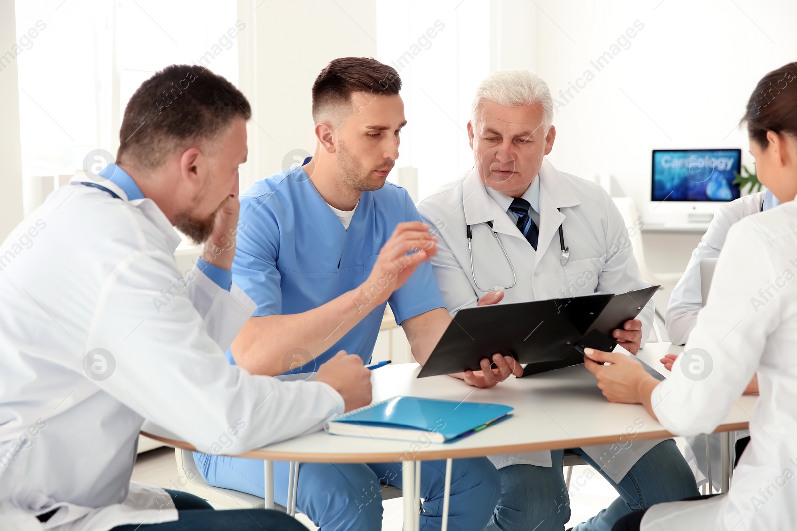 Photo of Group of doctors attending meeting in clinic. Cardiology conference