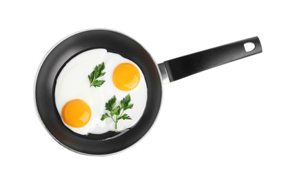 Photo of Tasty cooked chicken eggs with parsley in frying pan isolated on white, top view