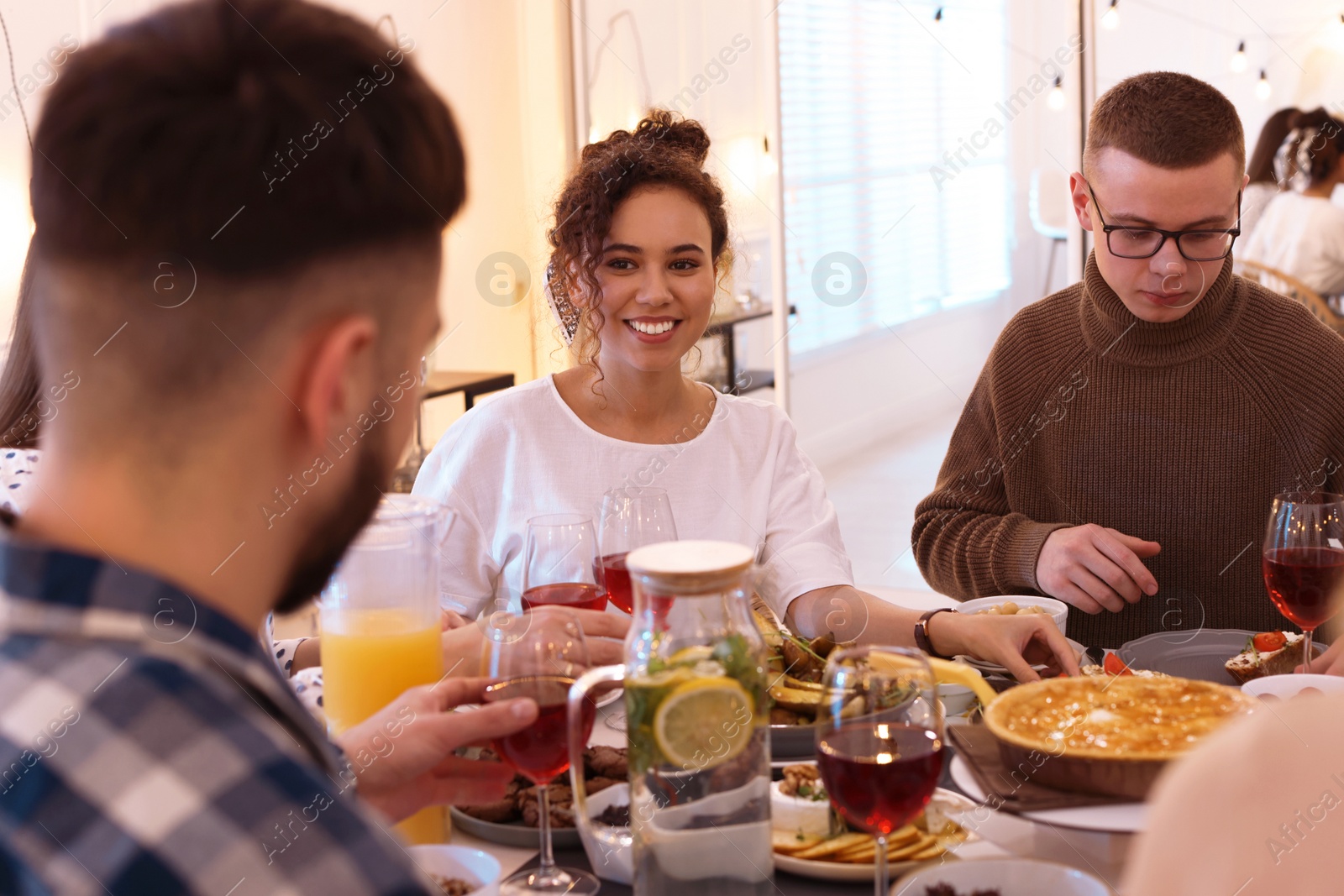 Photo of Group of people having brunch together at table indoors