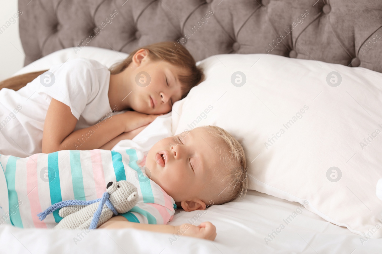 Photo of Little children sleeping in bed at home