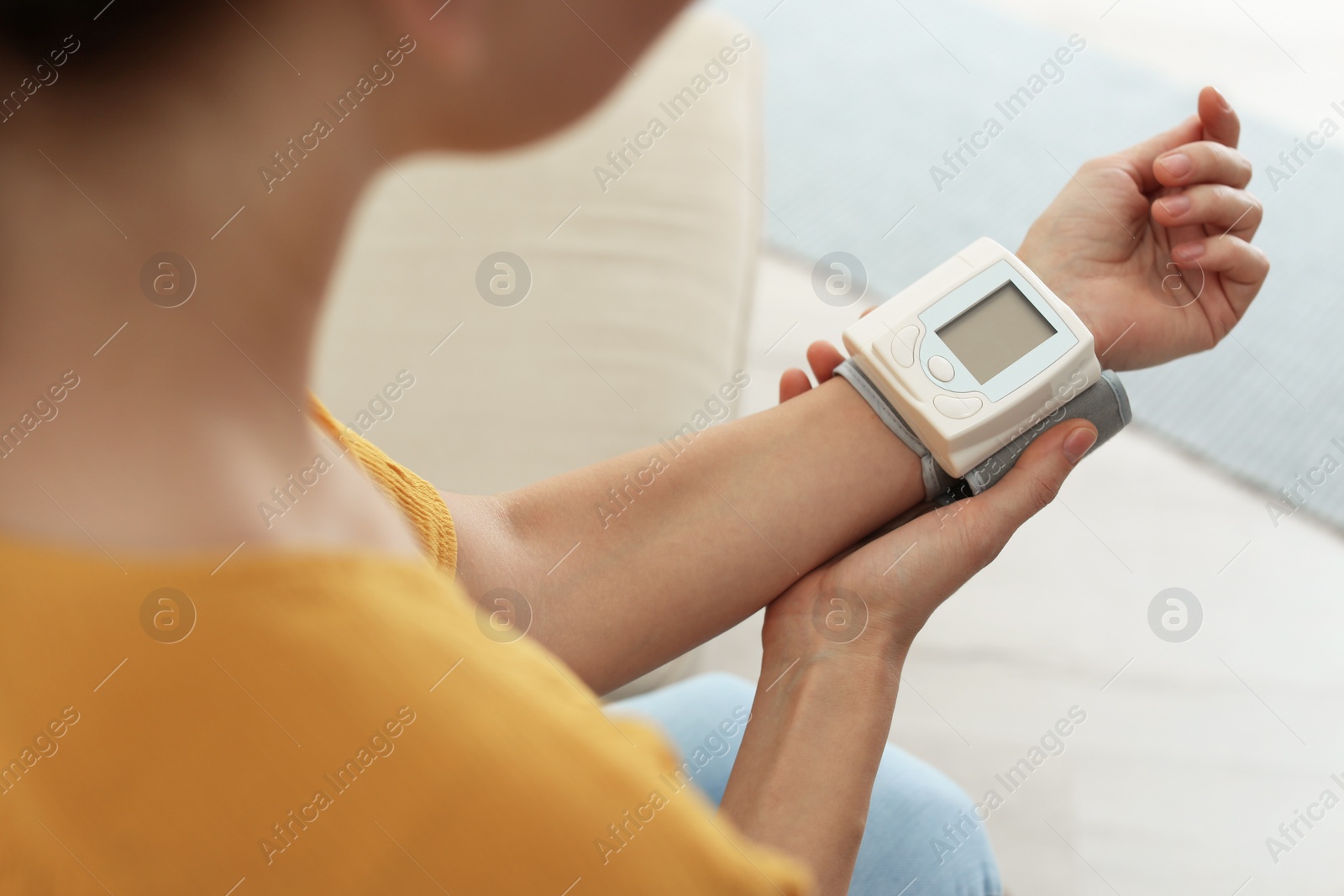 Photo of Woman checking blood pressure with sphygmomanometer at home, closeup. Cardiology concept