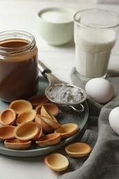 Photo of Ingredients for delicious walnut shaped cookies with condensed milk on white wooden table