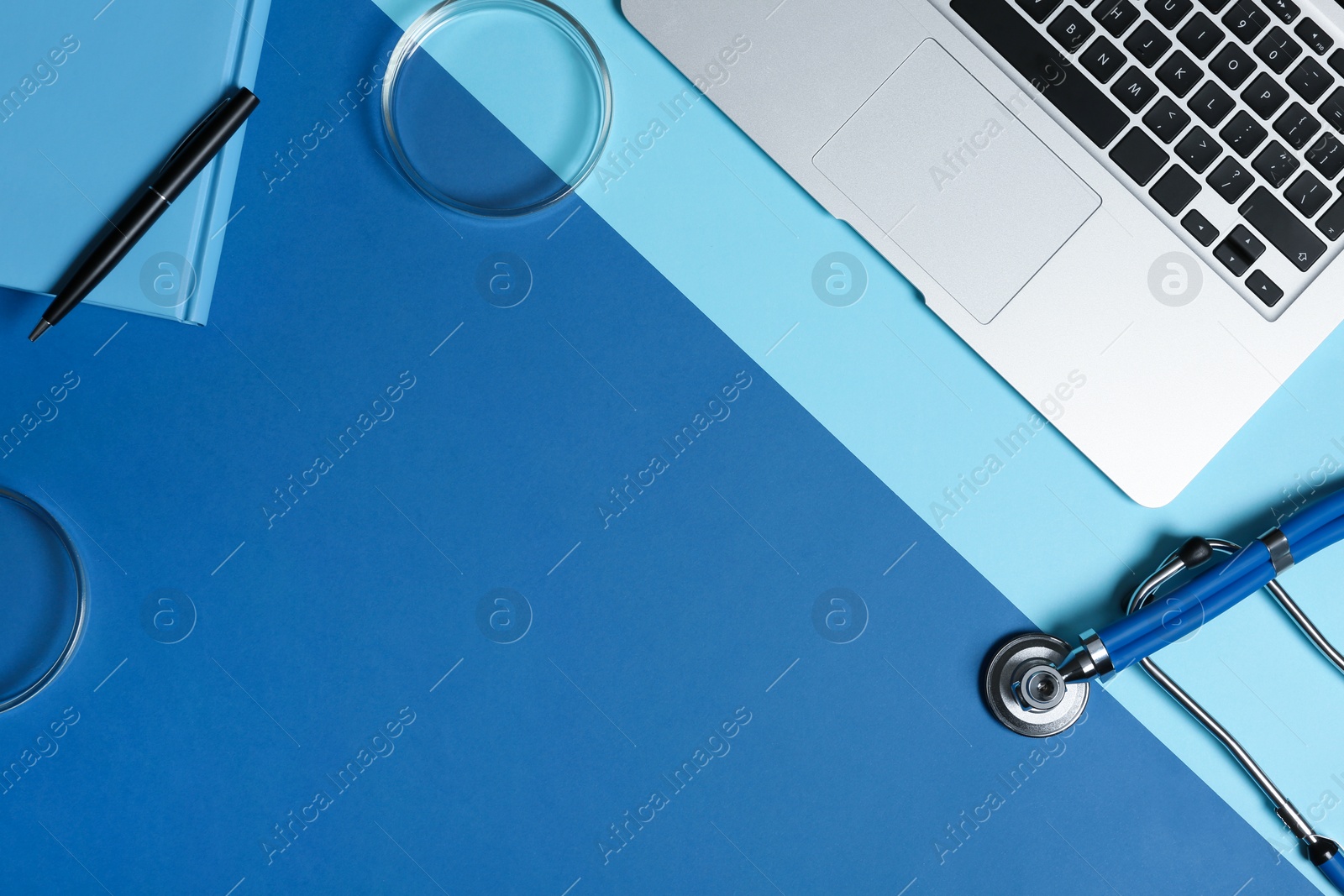 Photo of Modern laptop and medical students stuff on color background, top view. Space for text