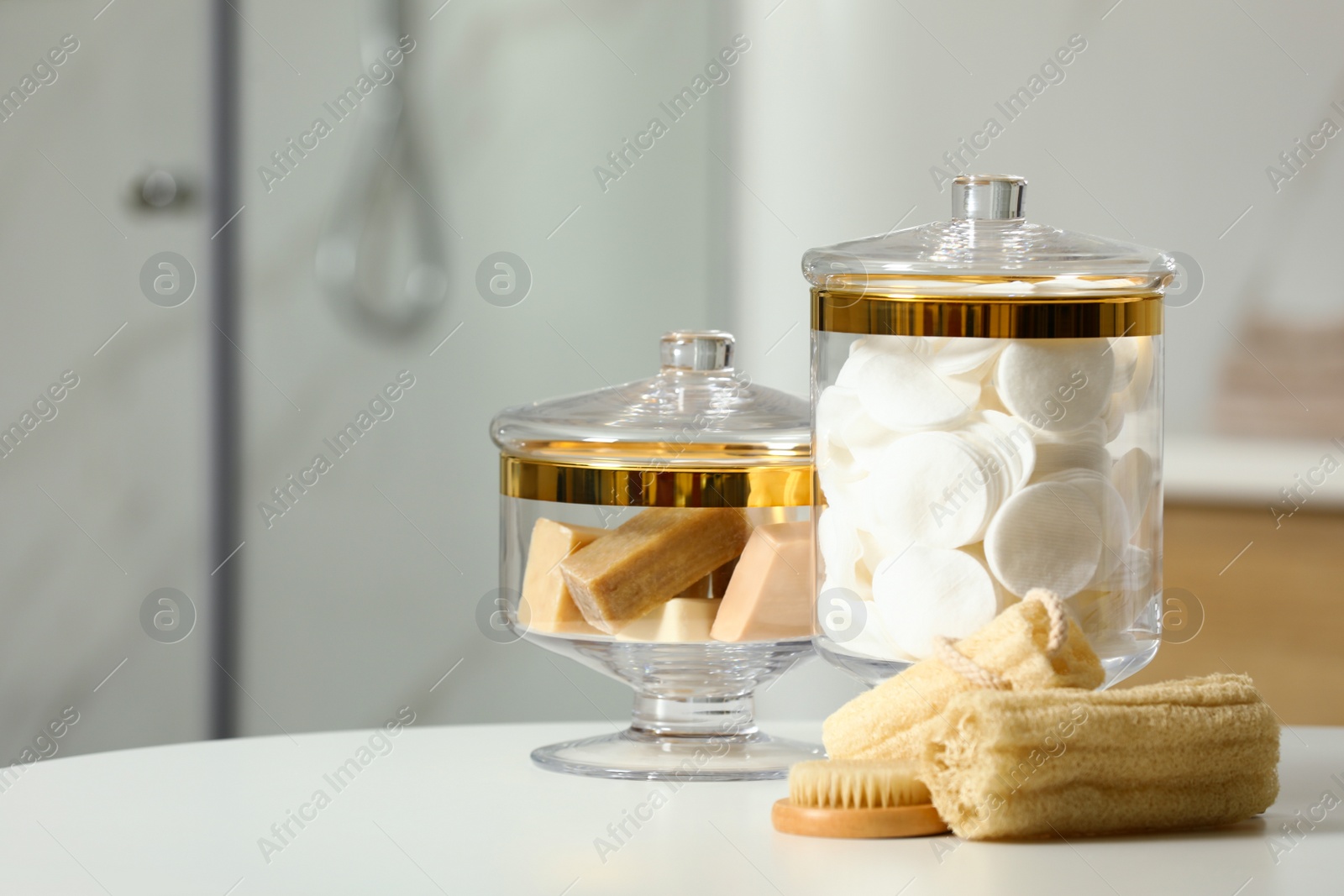 Photo of Composition of glass jar with cotton pads on table in bathroom. Space for text