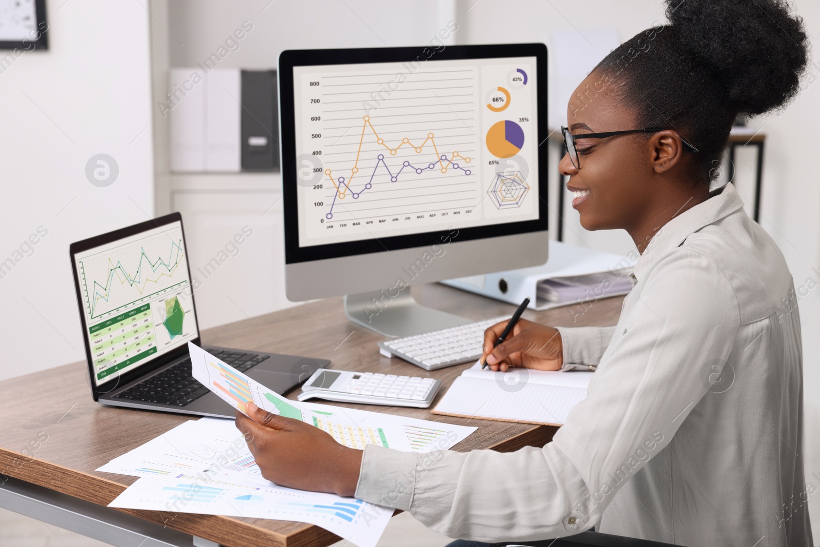 Photo of Professional accountant working at wooden desk in office