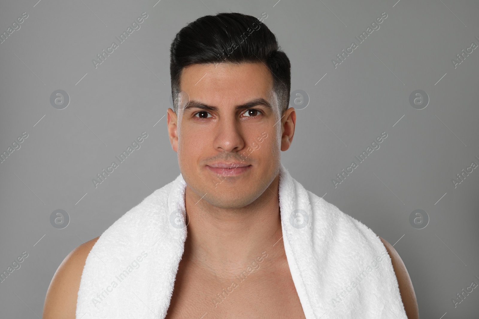 Photo of Handsome man after shaving on grey background