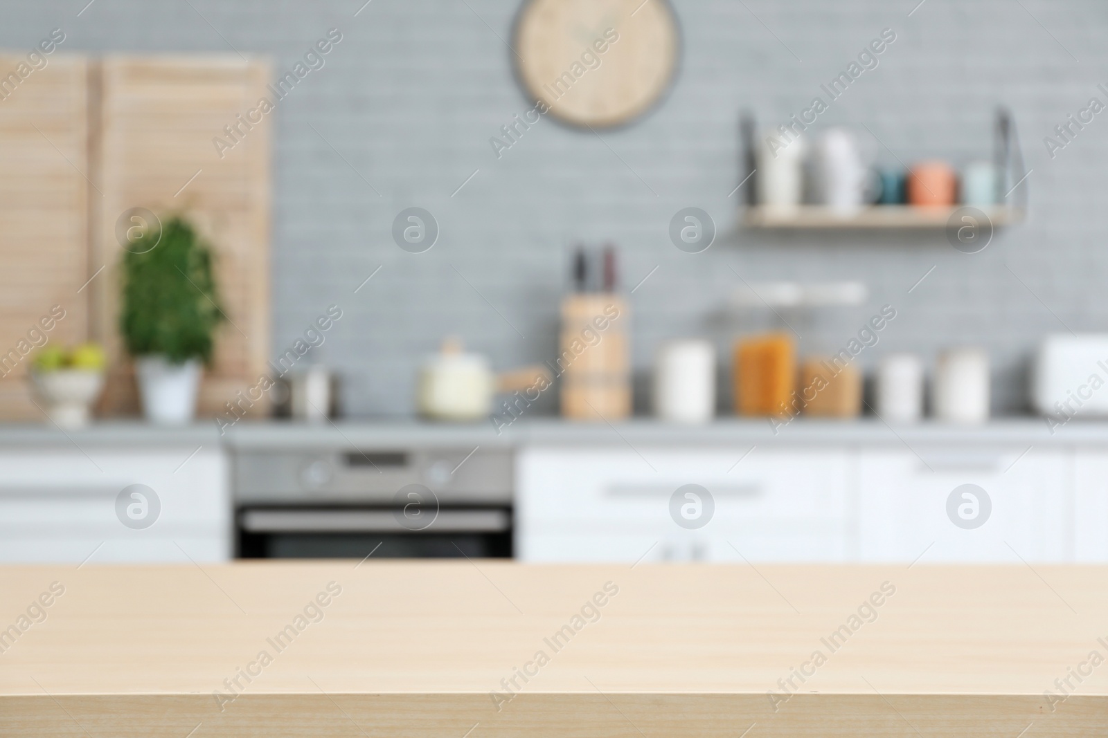 Photo of Empty table and blurred view of kitchen interior