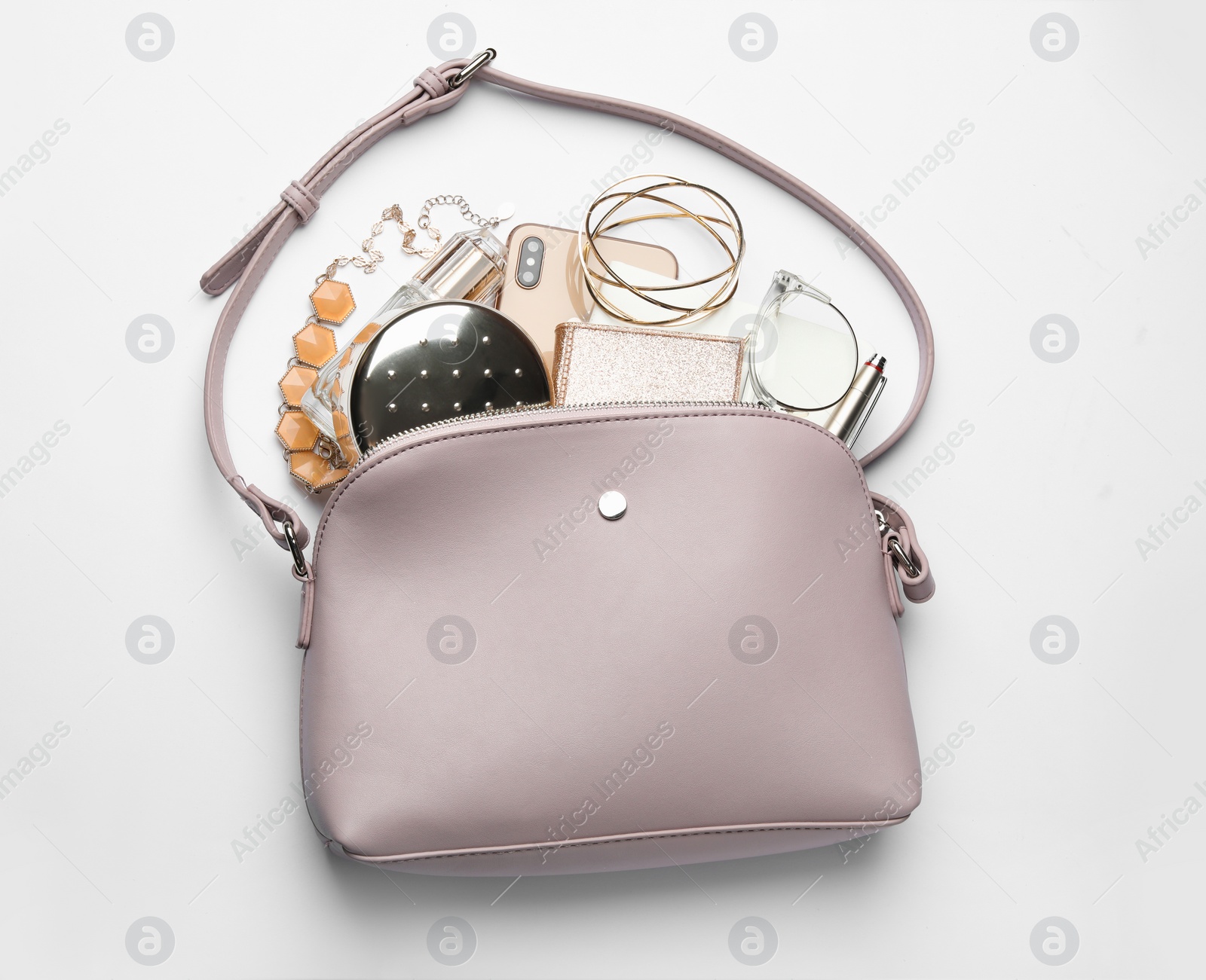 Photo of Stylish woman's bag with smartphone and accessories on white background, top view