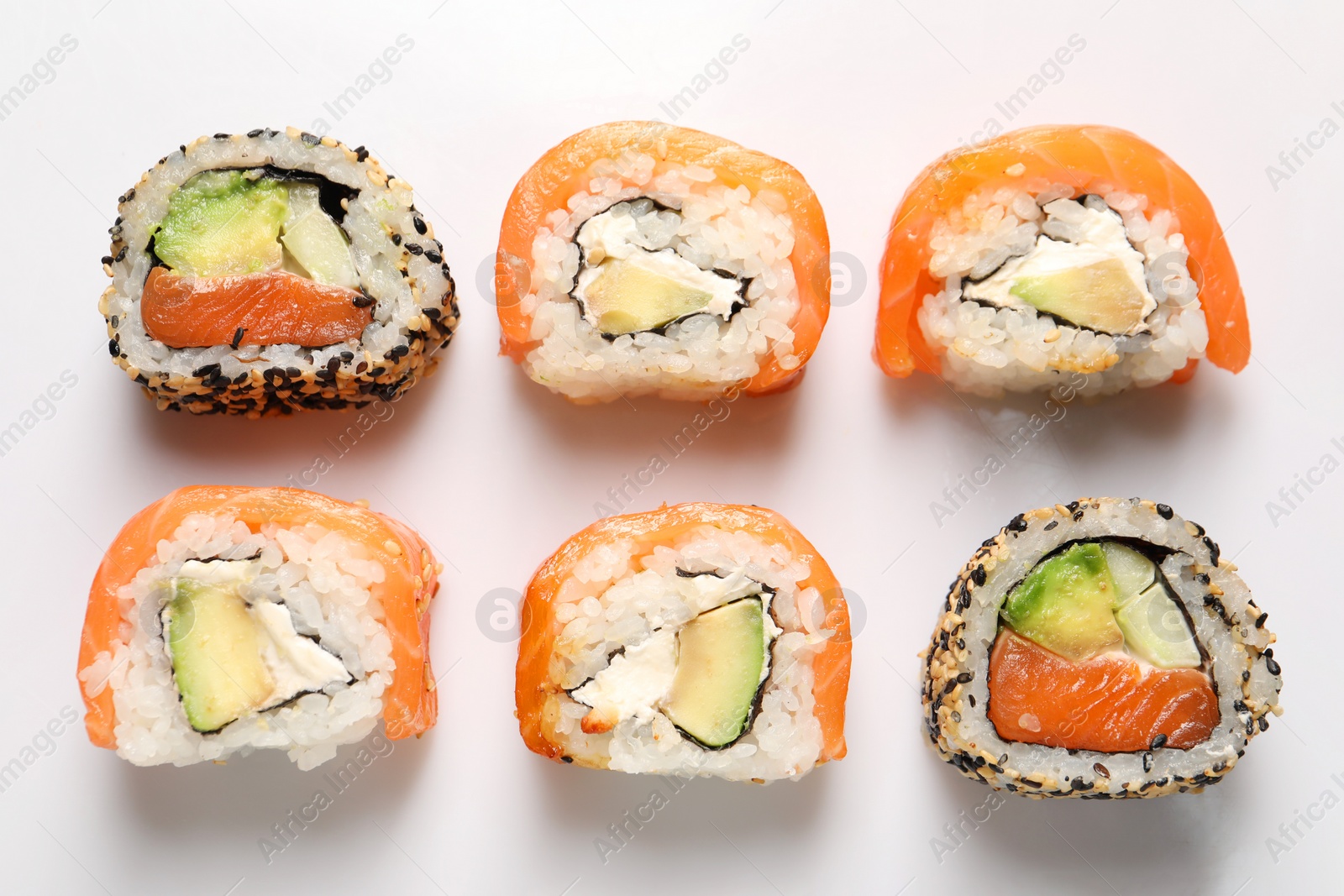 Photo of Delicious sushi rolls on white background, flat lay