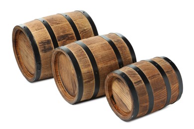 Photo of Three traditional wooden barrels on white background