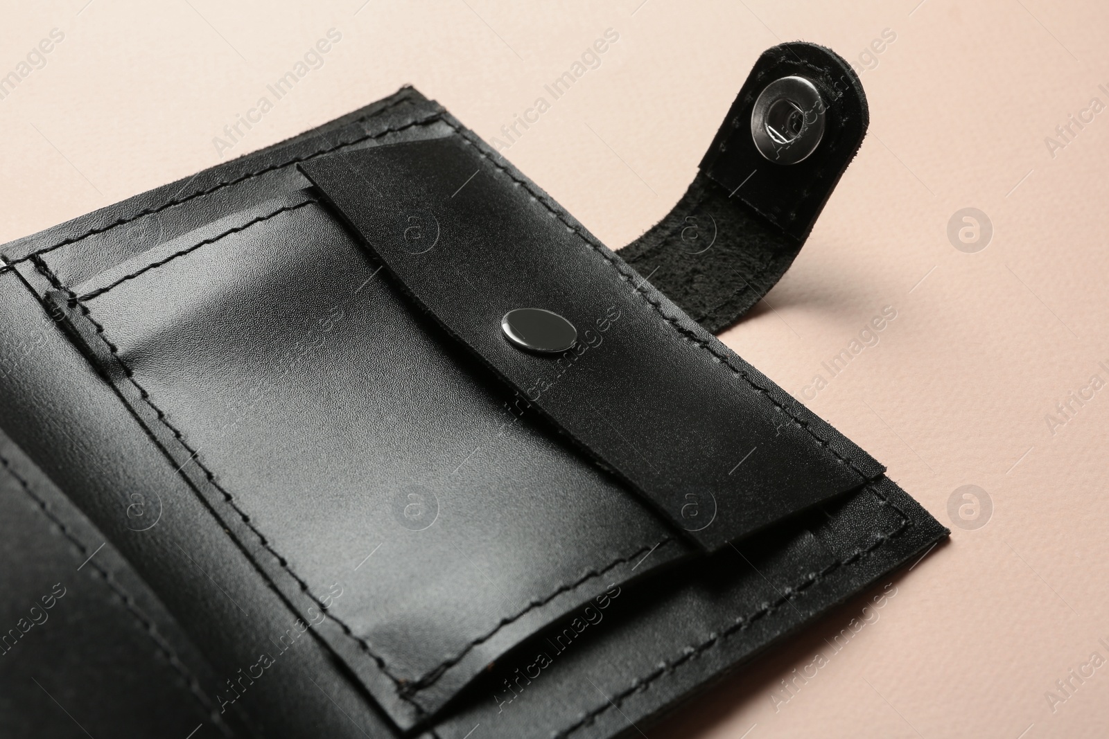 Photo of Open leather wallet on color background, closeup