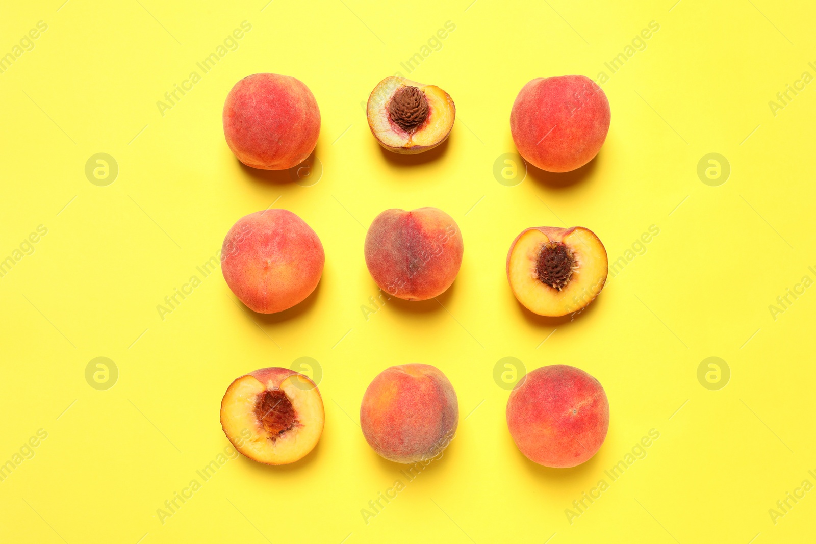 Photo of Delicious juicy peaches on yellow background, flat lay