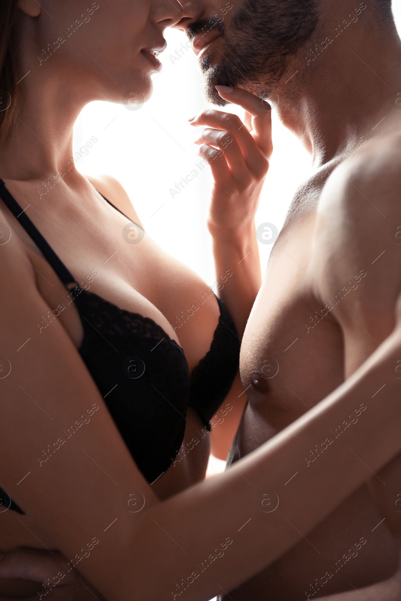 Photo of Passionate young couple at home, closeup view