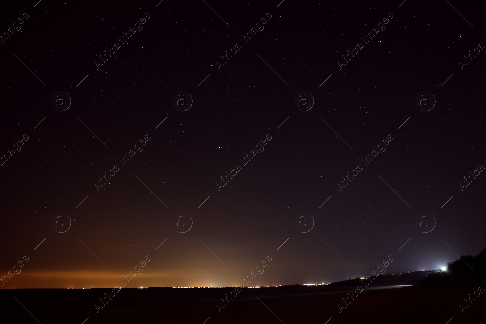 Photo of Picturesque view of starry sky at night on seaside