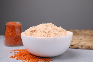 Lentil flour and seeds on white table, closeup